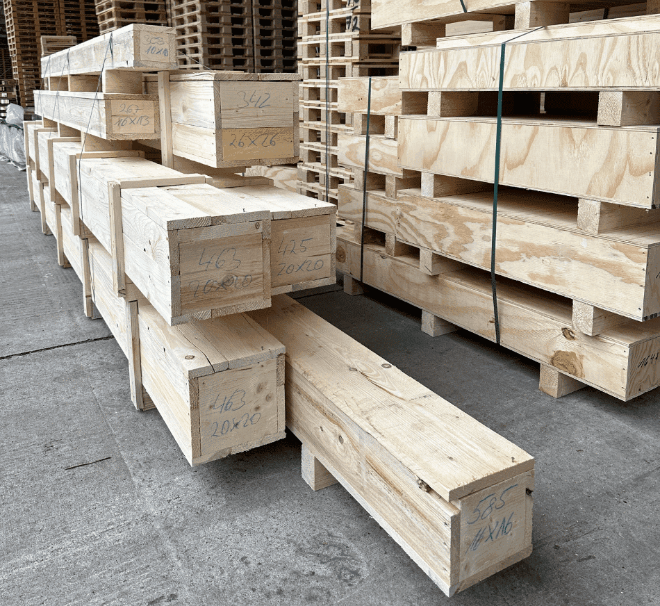 Stacked wooden pallets and timber crates for shipping and storage, suitable for construction or logistics.