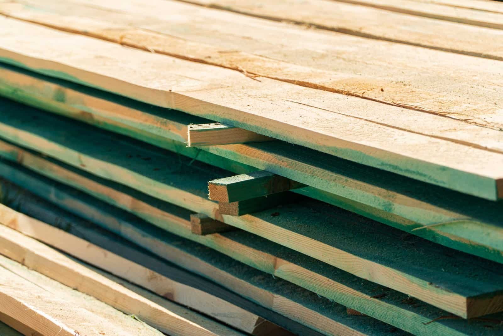 Close-up of stacked boards. Boards for building a house. Boards for roof construction. Boards building material. Construction.