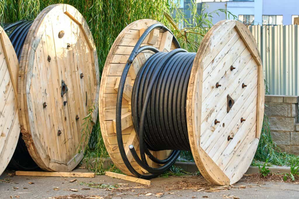 Coiled,Wire,Stored,On,Large,Round,Wooden,Spools,Prepared,For